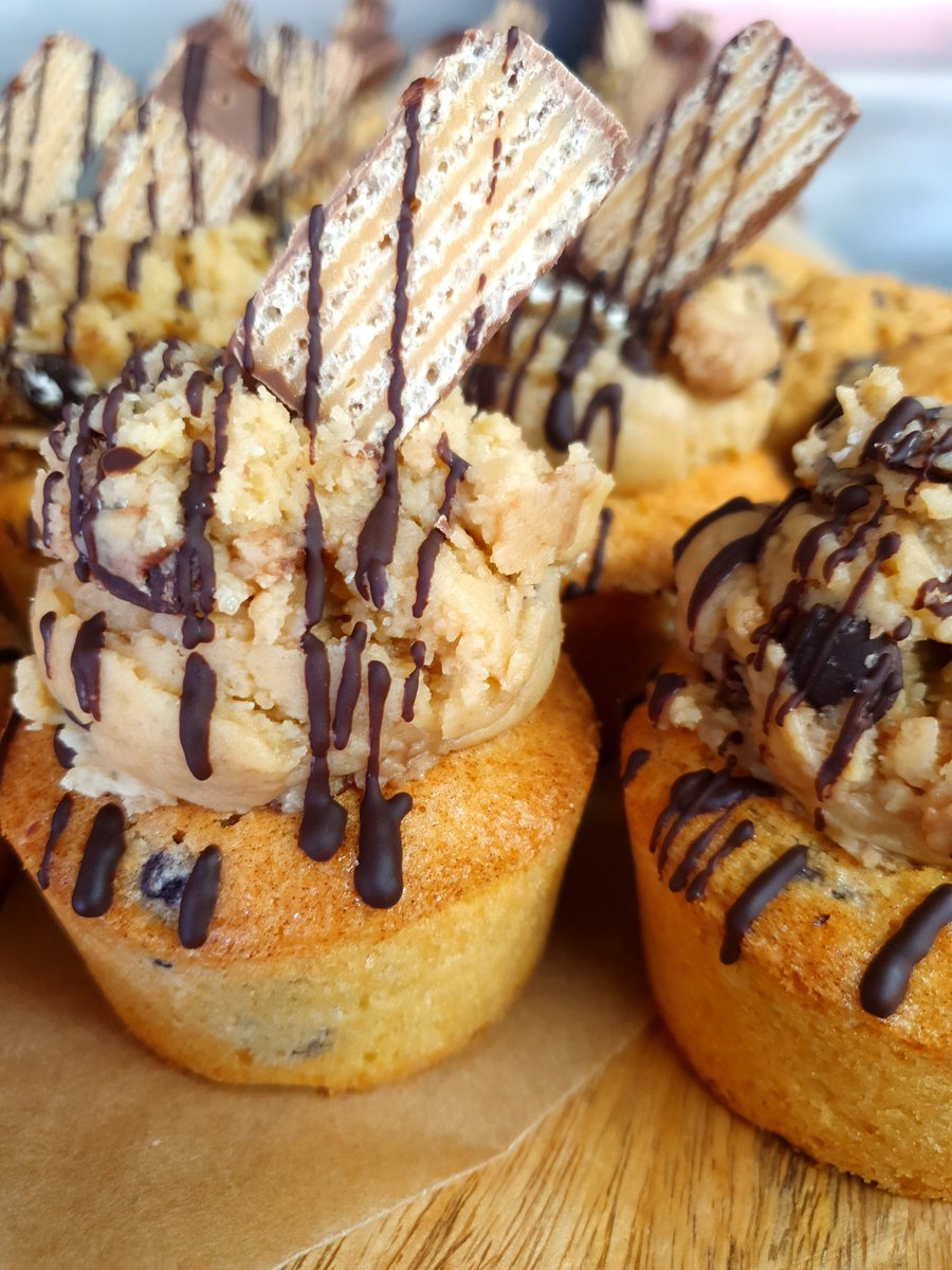 Cookie cups filled with chocolate ganache or salted caramel and topped with raw cookie dough
