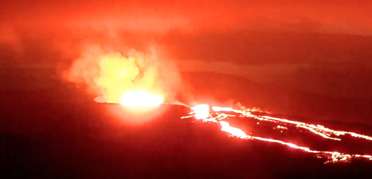 lava flowing down the volcano at night. red glow all around