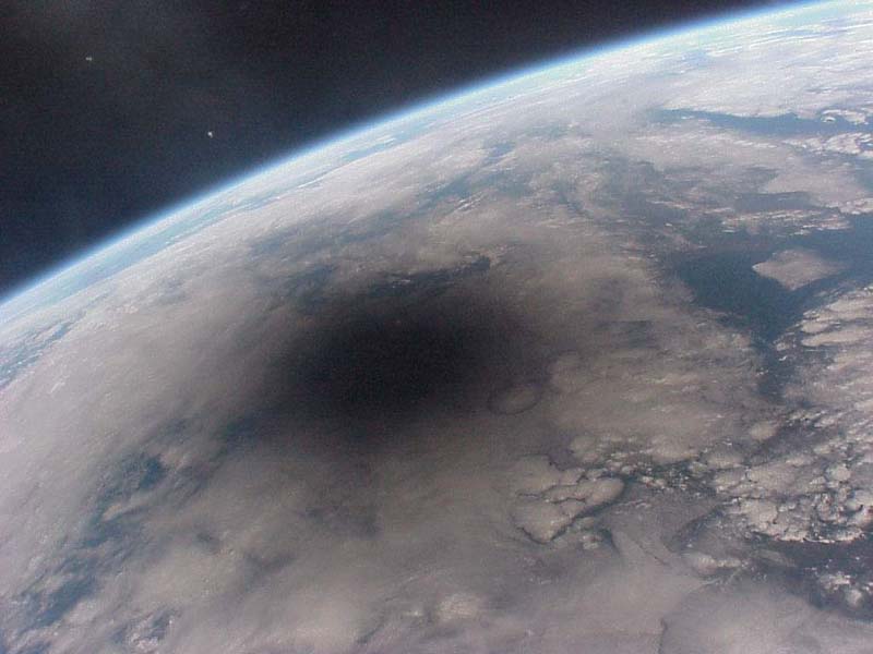What does a total solar eclipse look like from space? 

On this day in 1999, this photo of the Moon's shadow on Earth during a total solar eclipse was taken from the Mir Space Station. #IdeasThatDefy