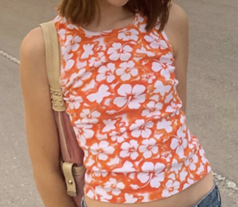 caitiedelaney's tweet photo. The absolute chokehold the hibiscus flower had on my late 90s fashion choices… walking around looking like an 11 year old Trader Joe’s apprentice https://t.co/ELDRXRQliS