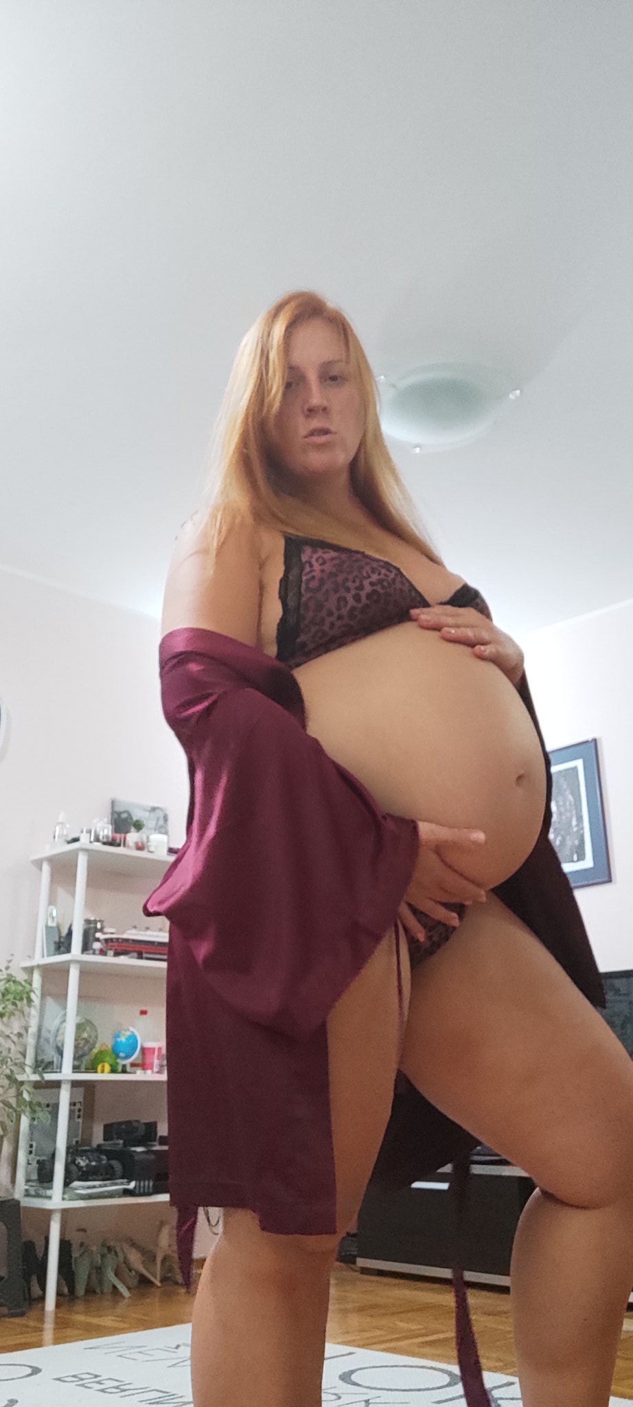 NiuraKoshkina proudly caressing the growing bump