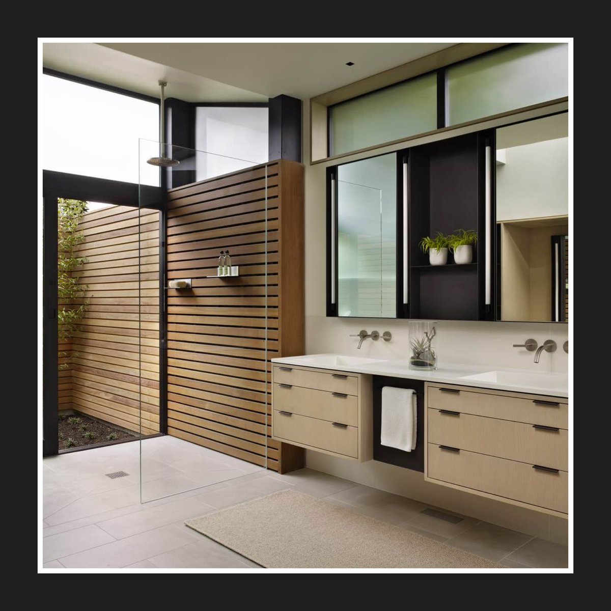 Conservatory_Gr's tweet photo. #DesignInspiration - This natural-inspired bathroom with the floating vanity and rain shower, create an elegant and calming space. The continuous indoor-outdoor wooden wall and black accents stand out against the sink and white walls! What's your favourite design element? https://t.co/hcwxQeV2dZ