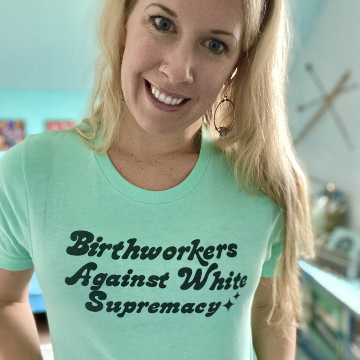 As @chinatolliver says: “Today is a great day to stand against white supremacy”. Go support the art and designs of China at RiseUpMidwife.com ✨ . . . . ID: 📸@nurturely founder Emily Little with teal “Birthworkers against white supremacy” tee by @chinatolliver