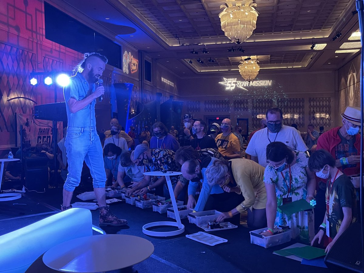 roddenberry's tweet photo. It’s an all-hands-on-deck moment, as fans pitch in to help @SamuelHatmaker1 find the missing pieces to finish their #Lego #Klingon Birds of Prey build on the #Roddenberry Interactive Stage at #STLV #55yearmission. https://t.co/XZYexwhjMN