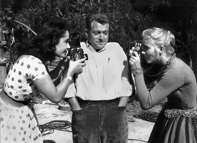 Elizabeth Taylor, photographer, Bob Willoughby and Eva Marie Saint playing around on the set of Raintree County.