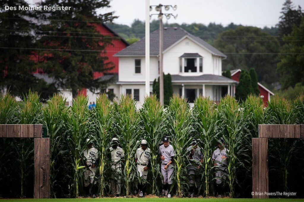 Players from the <a href="/whitesox/">Chicago White Sox</a> and @yankees walk out of the corn as they are introduced before the #mlbfieldofdreams game in Dyersville, #iowa. @mlb #baseball #whitesox #yankees