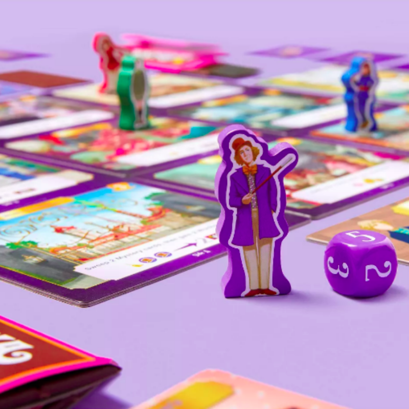 Wiggles3DGames's tweet photo. Shout out to our very own AC Atienza for designing The Golden Ticket Game, which you can find online and in stores of Target!! Play cards, steal candy, collect chocolate bars, and find the golden ticket! 
Also...those chocolate bars look DELISH! 😍😍