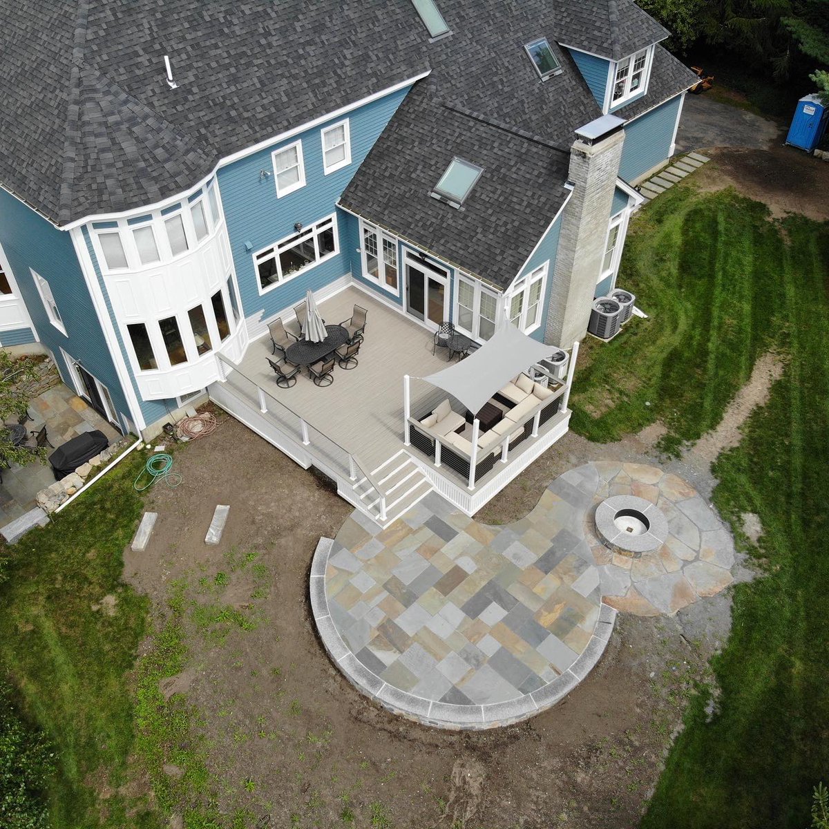Put the finishing touches on a beautiful natural cleft, full color bluestone patio complimented by goshen stone around the fire pit, all on top of a veneered wall.  #bluestone #hardscape #caledonia #firepit #goshenstone #kandrlandscape