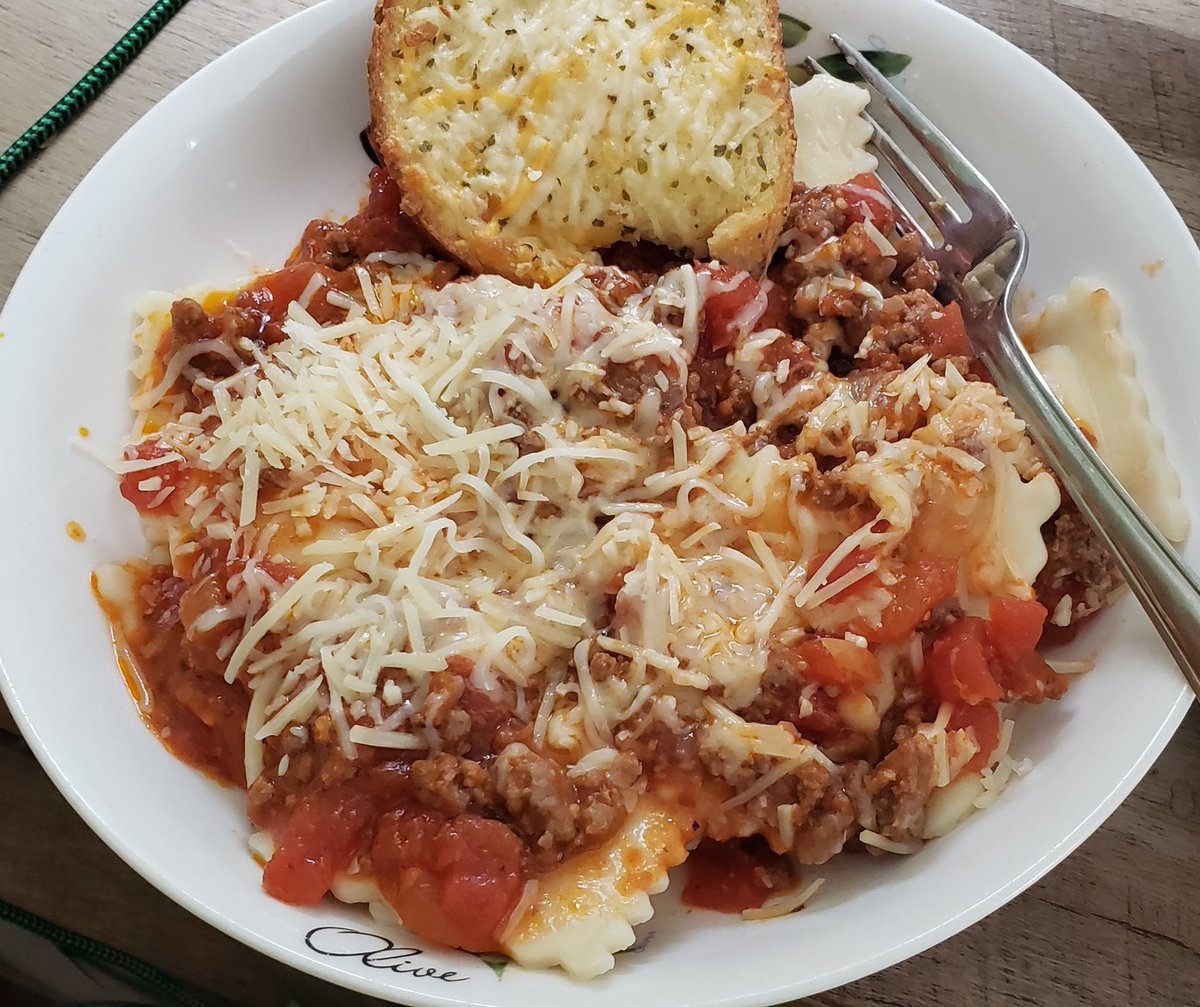 Cheese stuffed ravioli with meat sauce and garlic bread. Yum.