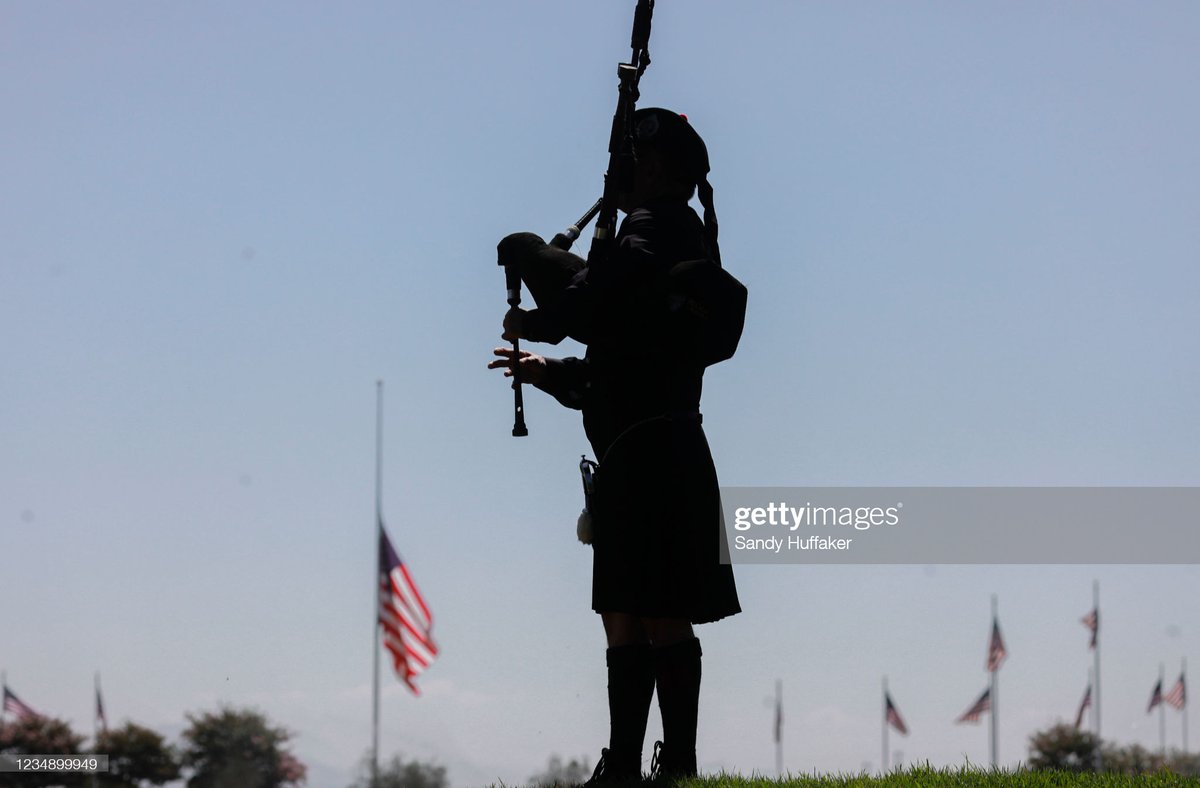 A bagpiper plays during a ceremony for fallen Navy Seals at Miramar National Cemetery in San Diego, California as a flag flies at half staff following the terrorist attack outside of the Kabul Airport that left as many as 170 dead. 📸: <a href="/Sandyhuffaker1/">Sandy Huffaker</a>