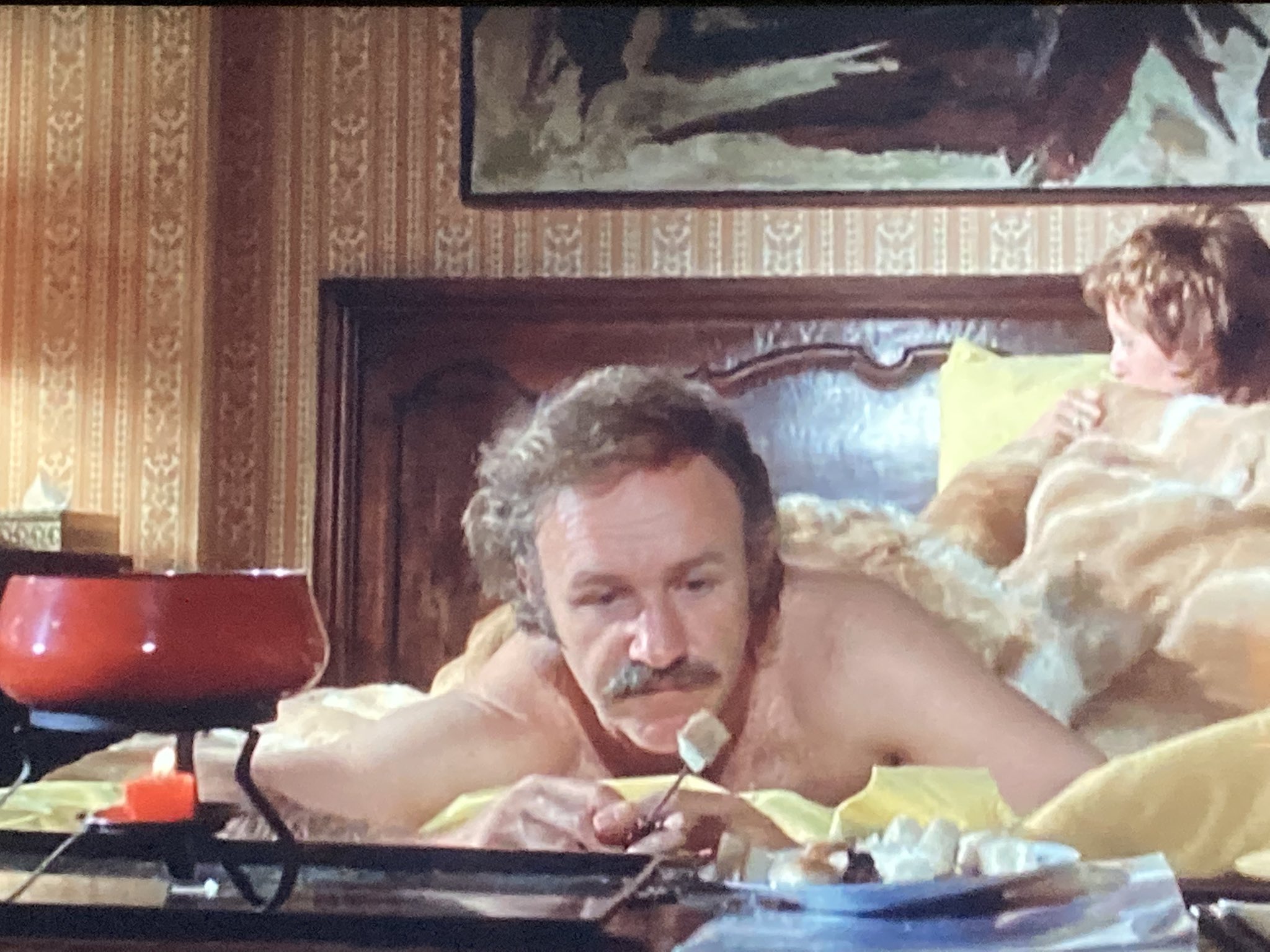 Minnow on X: Ive found the most 70s image in existence: Gene Hackman with  a porn stache, eating post sex fondu in bed, covered in a goddamn cowhide.  t.coW92uuuTyar  X