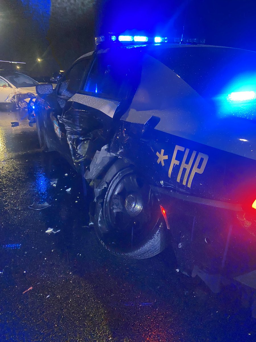 FHPOrlando's tweet image. Happening now: Orange County. Trooper stopped to help a disabled motorist on I-4. When Tesla driving on “auto” mode struck the patrol car. Trooper was outside of car and extremely lucky to have not been struck. #moveover.  WB lanes of I-4 remain block as scene is being cleared.