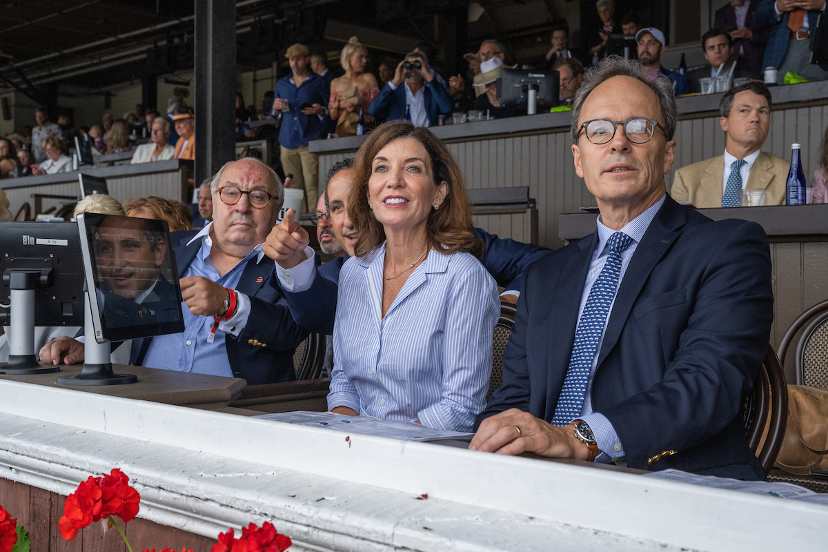 Governor Hochul (center) sits with her husband (right) in spectator box at 152nd Travers Stakes at the Saratoga Springs Race Track
