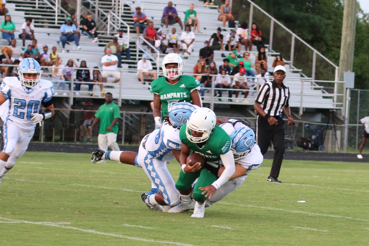 Cleveland's KD Harrison (30) and Brady Thompson (24) tackle Rose's ball carrier