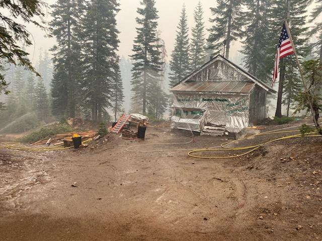 Klamath_NF's tweet image. Fire crews protect values at risk in many ways. In these photos crews are utilizing structure wrap and sprinklers to protect structures in the path of the #AntelopeFire.