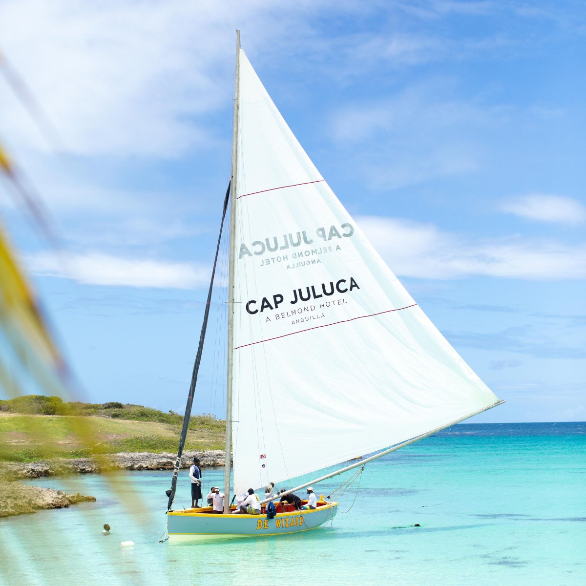 Anguilla_Trsm's tweet photo. @CapJuluca is proud to anchor itself further in Anguilla's vibrant culture with the sponsorship of De Wizard, a community racing boat. This vessel takes claim to the Caribbean with a billowing sail emblazoned with Belmond Cap Juluca's name and distinguished captain and crew! https://t.co/gLEZTFG12N