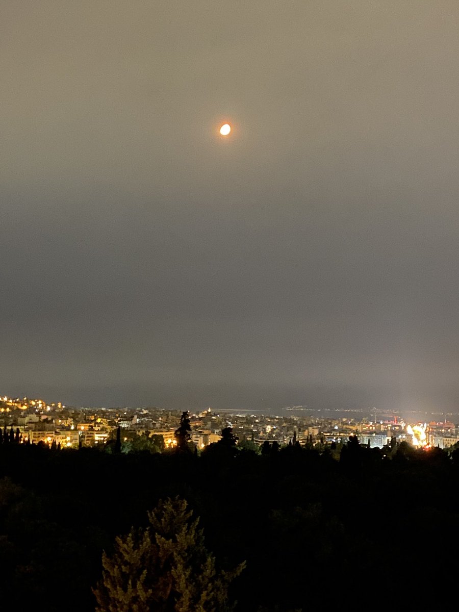 A red #moon hovers over the #Athens night sky, brought about by the surrounding forest fires blazing in the suburbs.