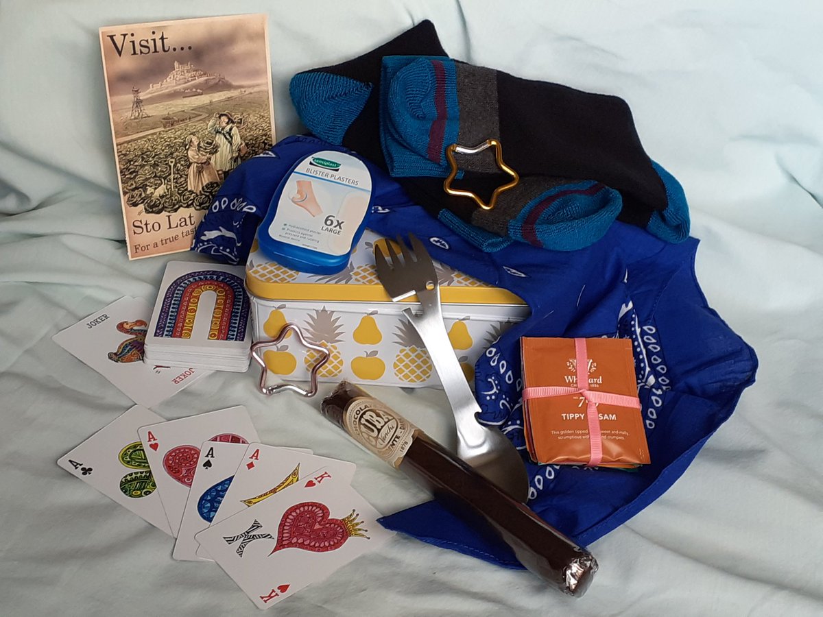 The halfway reward for the Borogravia battlefield walk is a care package of useful things for a long hike. Socks, a hanky, tea, blister plasters, a spork, carabiners, a chocolate cigar, a postcard from one of the many Discworld benevolent societies and some playing cards I made.
