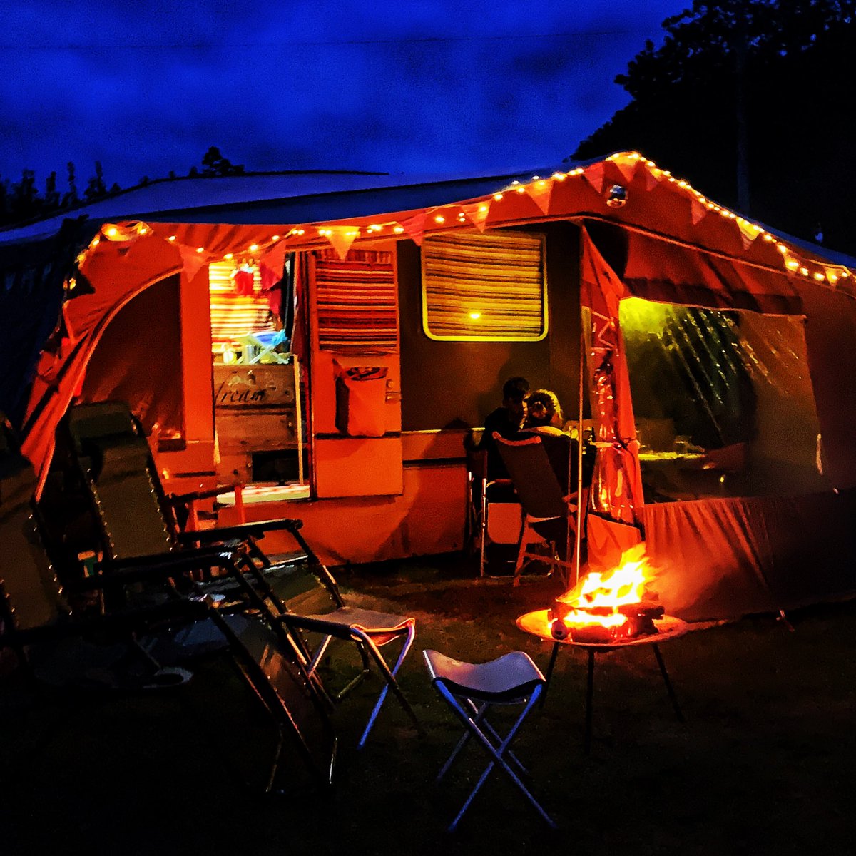 theneilwragg's tweet photo. Currently sat by a campfire on a family hol in my restored 40yr old camper. Without a sewing machine this wouldn’t have been possible - cushions, blinds, chairs, bunting, bedding etc All hail the sewing machine! @KirstieMAllsopp #sewing #upcycling https://t.co/pn4tlY6kxi