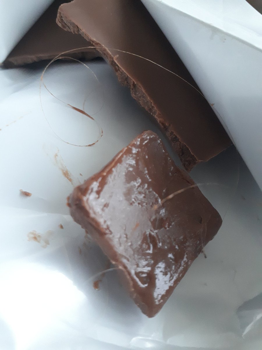 lminprison's tweet photo. @CadburyUK Was enjoying your caramel chocolate and felt a hair on my tongue. The hair IS INSIDE THE CHOCOLATE 😭😭😭 WHAT THE HELL CADBURY???? https://t.co/HbzzidYQSW