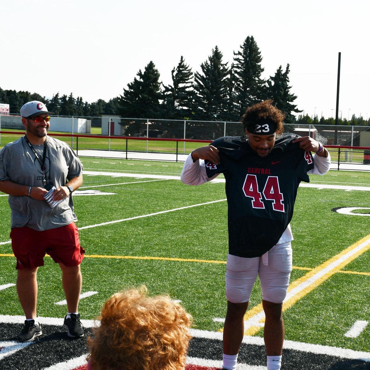 CWUFB's tweet photo. At the start of practice today @CoachFisk presented senior Donte Hamilton with the 44 jersey, signifying him as the captain of the defense #ReignCrimson https://t.co/ut68xFf5VD