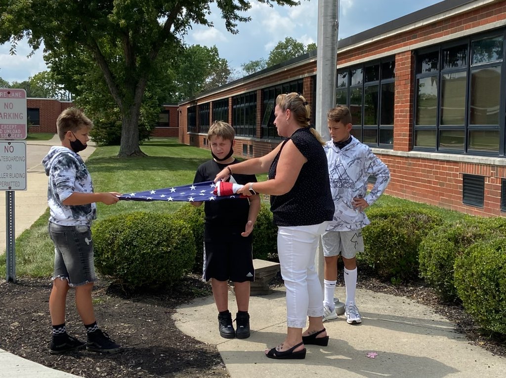 The flag crew gets a lesson in folding the flag. Yes, we put it up and take it down every day.