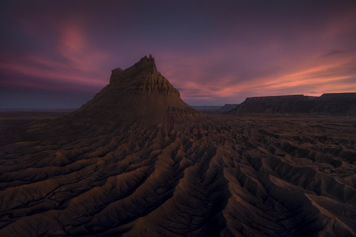 A butte in Utah eroding over the passage of time by wind and water.