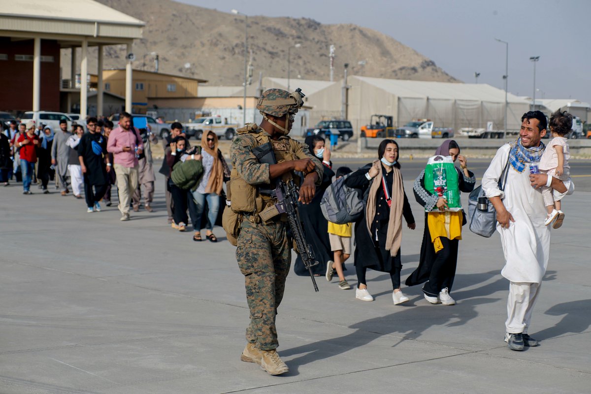 DeptofWar's tweet photo. .@USMC Marines assigned to 24th Marine Expeditionary Unit escort Afghan civilians to a C-17 Globemaster III at Hamid Karzai International Airport in Kabul, Afghanistan. #HKIA https://t.co/UVCEMNlE0q