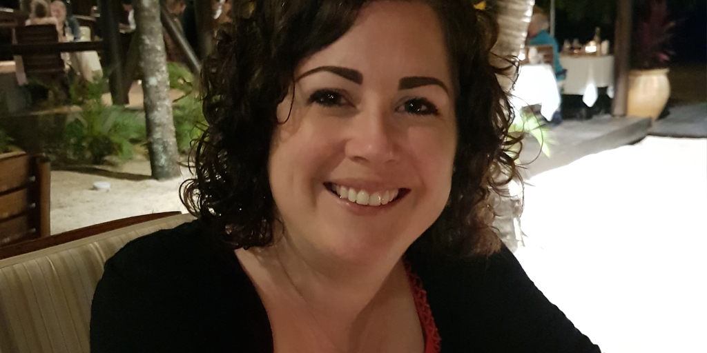 Image shows Nina smiling to camera