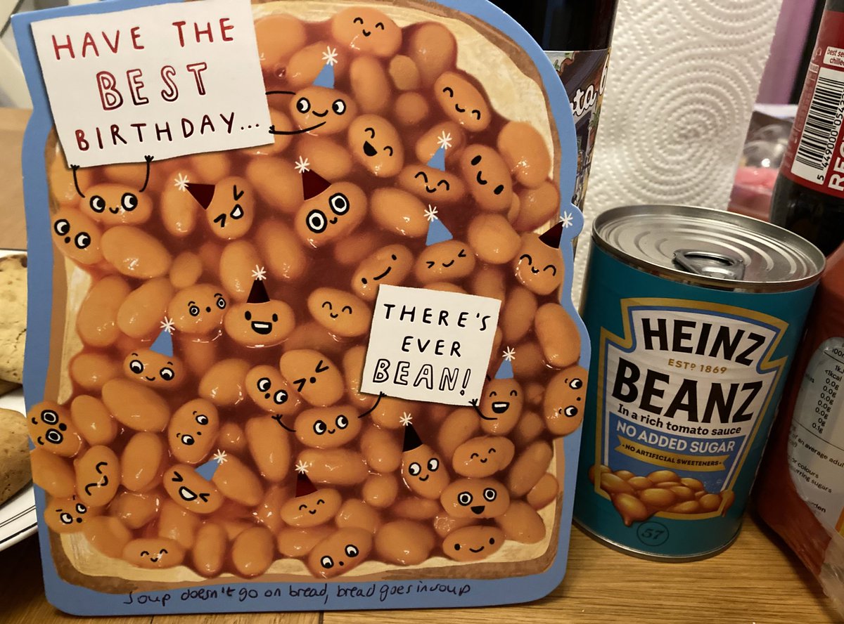 A birthday card feathering baked beans, and a tin of baked beans