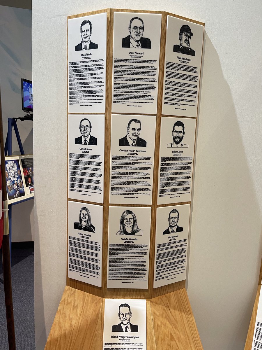 Neal Henderson and the plaques of the US Hockey Hall of Fame Class of 2019.