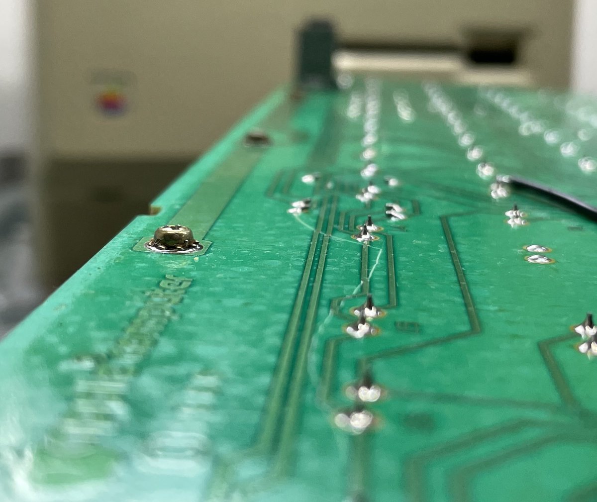 This little Mac 512k that’s gotten a RAM, SCSI, and ROM upgrade to effectively make it a Mac Plus runs great except the top half of the keyboard didn’t work.
Found this crack running the length of the board, looks like I’ve got a lot of traces to patch with bridge wire…