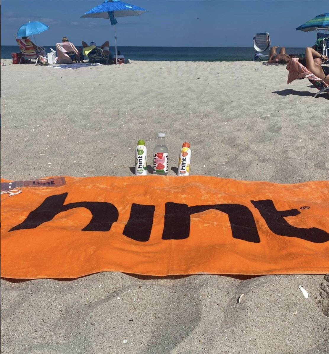 hint's tweet photo. Whether it’s the beach or the pool, no summer day is complete without one of those fancy Hint towels! RT this for a chance to win a case of Hint Water, a Hint Sunscreen, and one of our limited-edition orange Hint towels! 🏖☀️💧 We’ll pick 5 lucky winners. #giveaway https://t.co/5c95hTQWsi