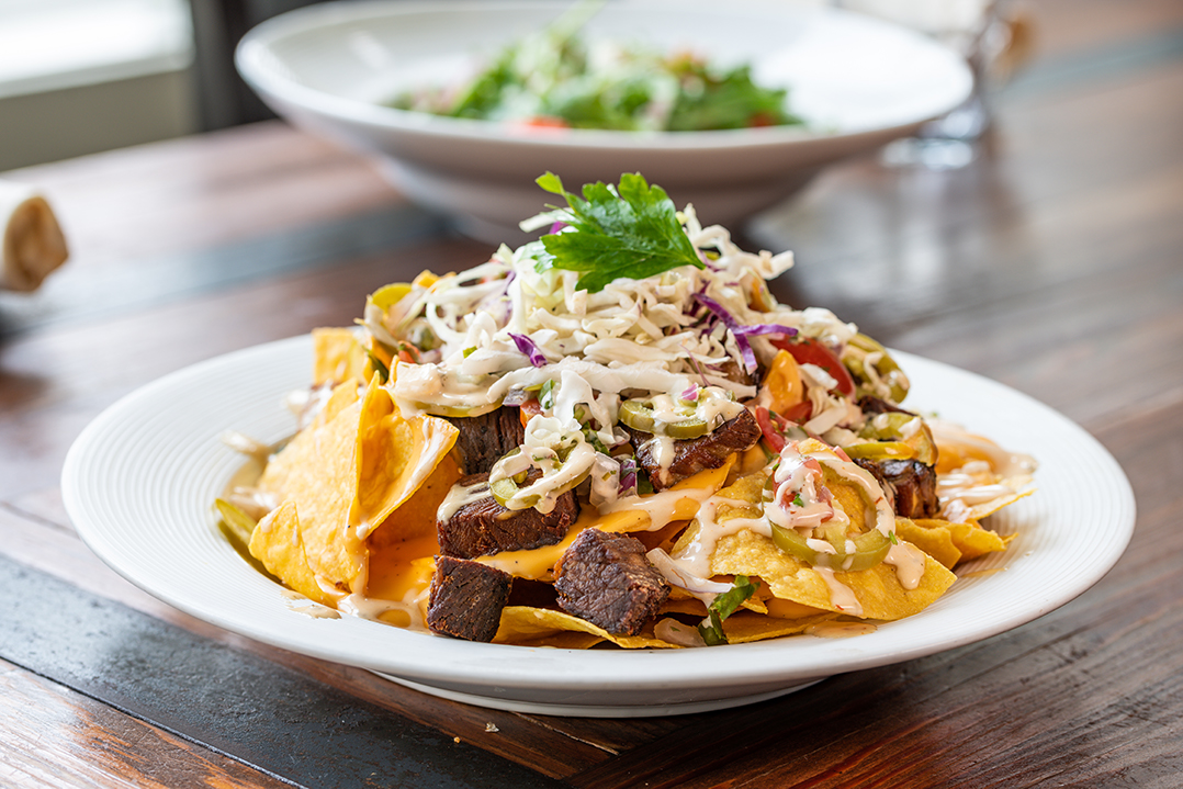 theturnhouse's tweet photo. Indulge in our juicy House Made Brisket Nachos served with Beer Cheese, Sour Cream, Smoked Brisket, Salsa Crudo, Pickled Vegetables, and Chipotle Ranch. Tag someone who loves dressed up nachos as much as you! 

#theturnhouse #eatlocal #shareablesfromthefarm #brisketlovers #mdfood https://t.co/FNIHMjYUcu