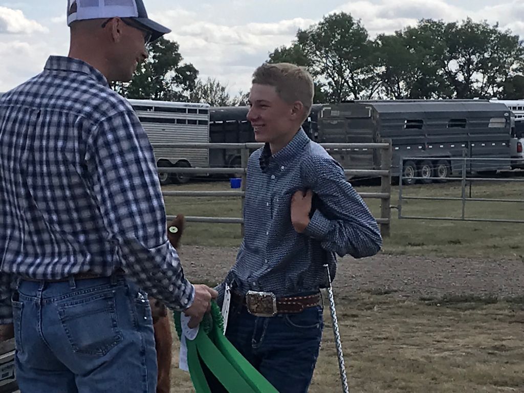 All smiles over here! Congrats to Chase B. for winning the Grand Champion Heifer Calf competition! <a href="/AginMotion/">Ag in Motion</a> Livestock Days