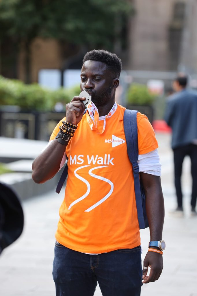 A man kissing his medal from the MS Walk.