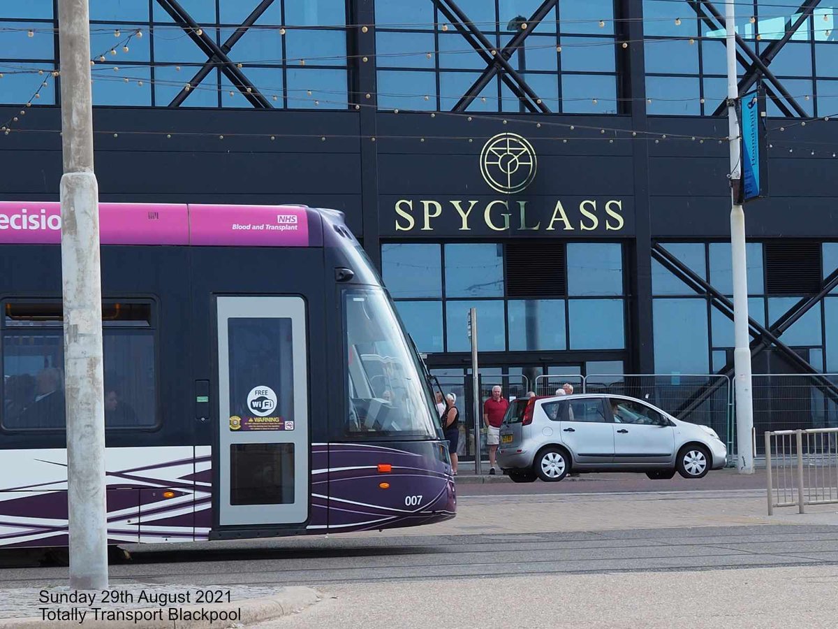 Blackpool Tram passing the new bar soon to open on the prom.  Its name is Spyglass.