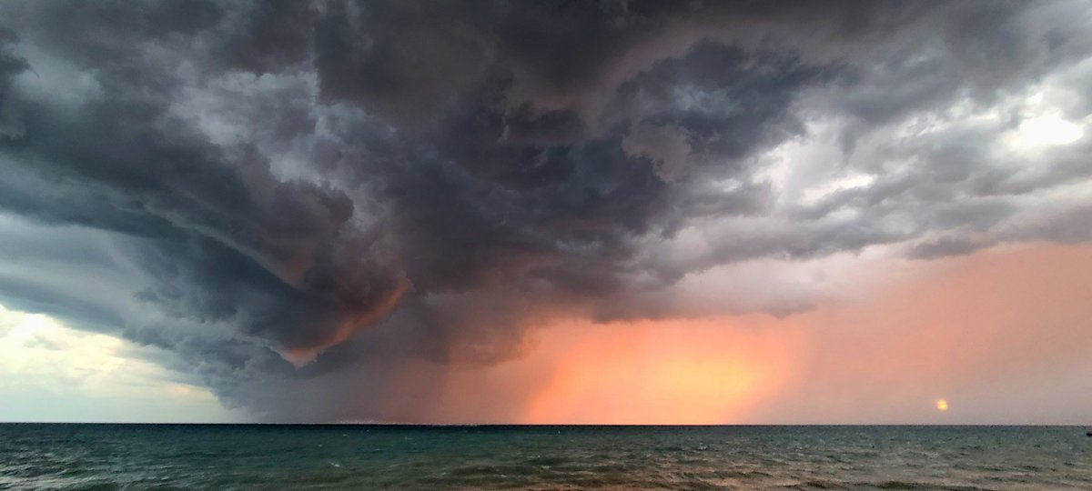 My jaw is on the FLOOR. Shelf + setting sun in the background with the most haunting hue I've ever seen. Best photo I have EVER taken. Bayfield Pier? 7:54pm #ONStorm #Onwx