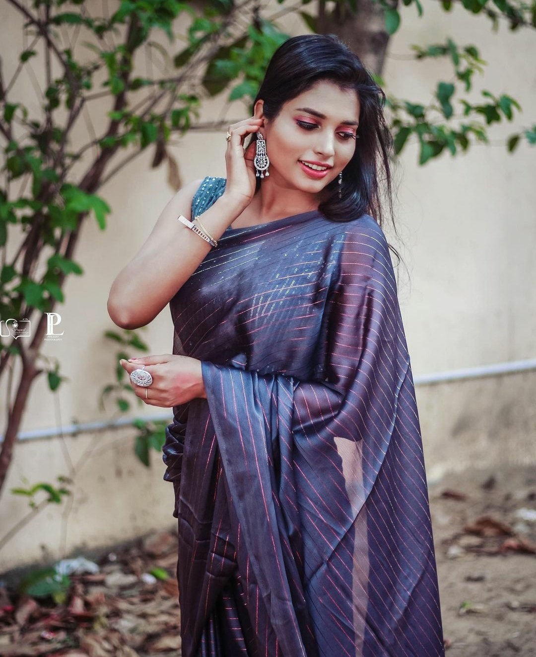 Image of Indian traditional Beautiful Woman Wearing an traditional Saree  And Posing On The Outdoor With a Smile Face-TF084719-Picxy