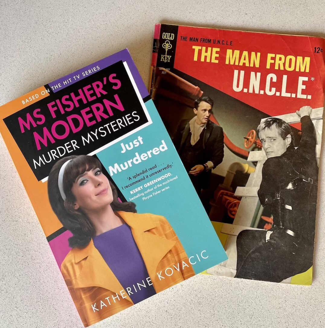 KathKov1's tweet photo. Fighting crime in the 1960s. The men from U.N.C.L.E. look worried, but not #MsFisher! @AllenAndUnwin @EveryCloud_TV @AcornTVANZ #CrimeFiction #book #JustMurdered #1960s @BplusPNews @SistersinCrimeA https://t.co/C0qYbYysI2