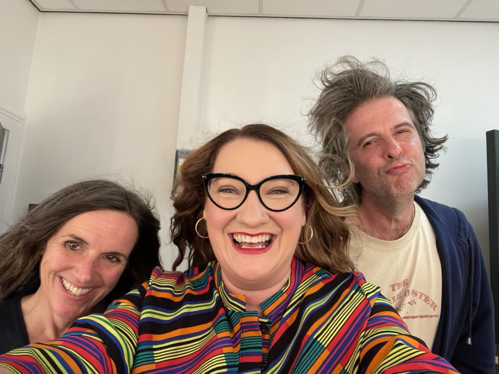 Photo description.
It’s the backstage gang in the lovely dressing room at Bridlington Spa. There was a big fan (oo-er Missus) backstage so we turned it on and Beyonce-d the fuck out of it. All of our hair is blowing and it looks pretty glam. I’m wearing a multi coloured dress by Zuri and red lipstick.