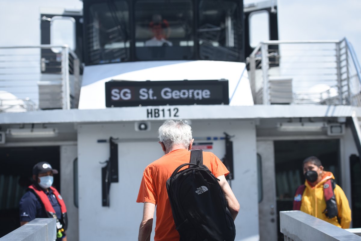 A photo of someone boarding an NYC Ferry.