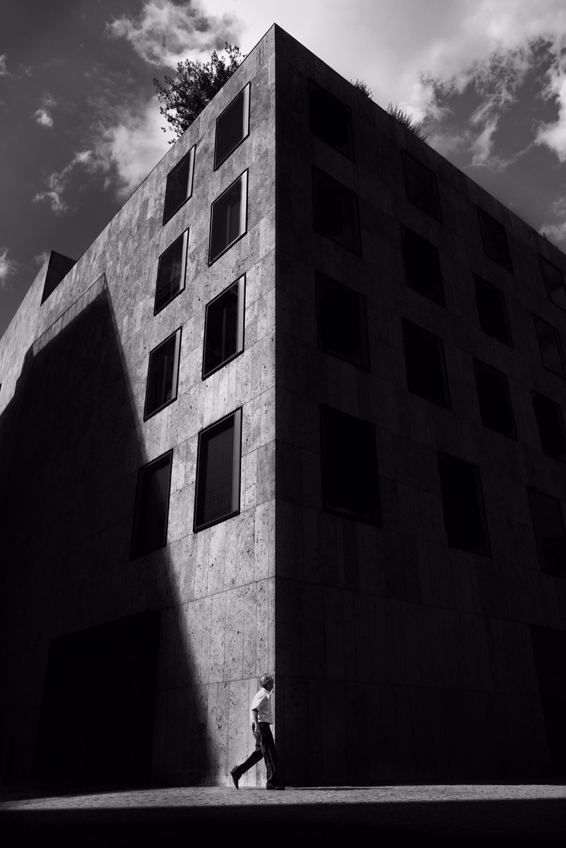 High Contrast Black and white monochrome street picture. Emphasising only the important areas while the shadows fall into negative space 