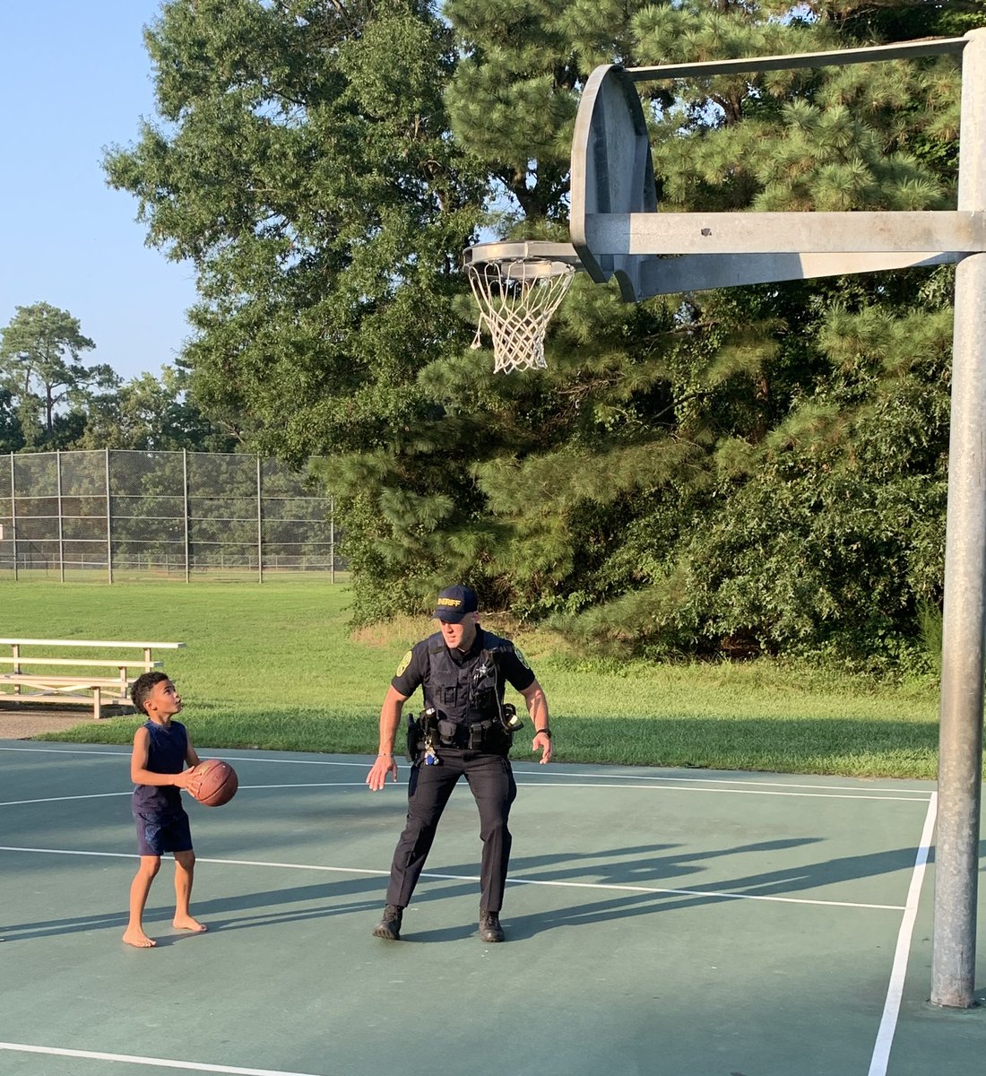 YorkPoquosonSO's tweet photo. Deputy Ulintz was an awesome York High basketball player.  Tonight he took his skills to the courts at Kiln Creek Park with his new friend Isaiah. #shoothoops #ypso https://t.co/n1iJOTXvFb