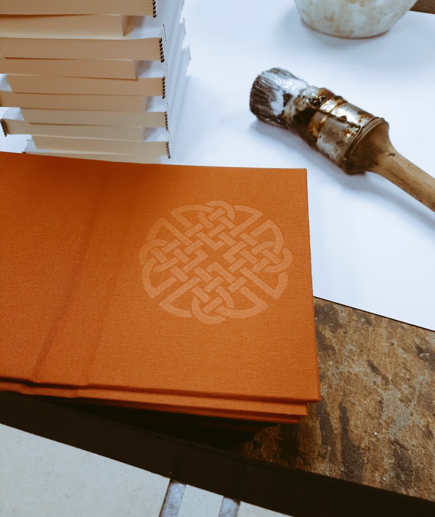 Casing in our hand bound notebooks this morning..pictured is the Celtic design of the Dara Celtic Knot, blind debossed on linen finish bookcloth. #bookbinding #madelocal