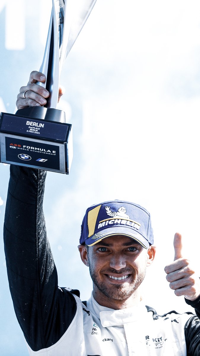 Edo with a silver trophy aloft in his right hand and showing a thumbs up with his left