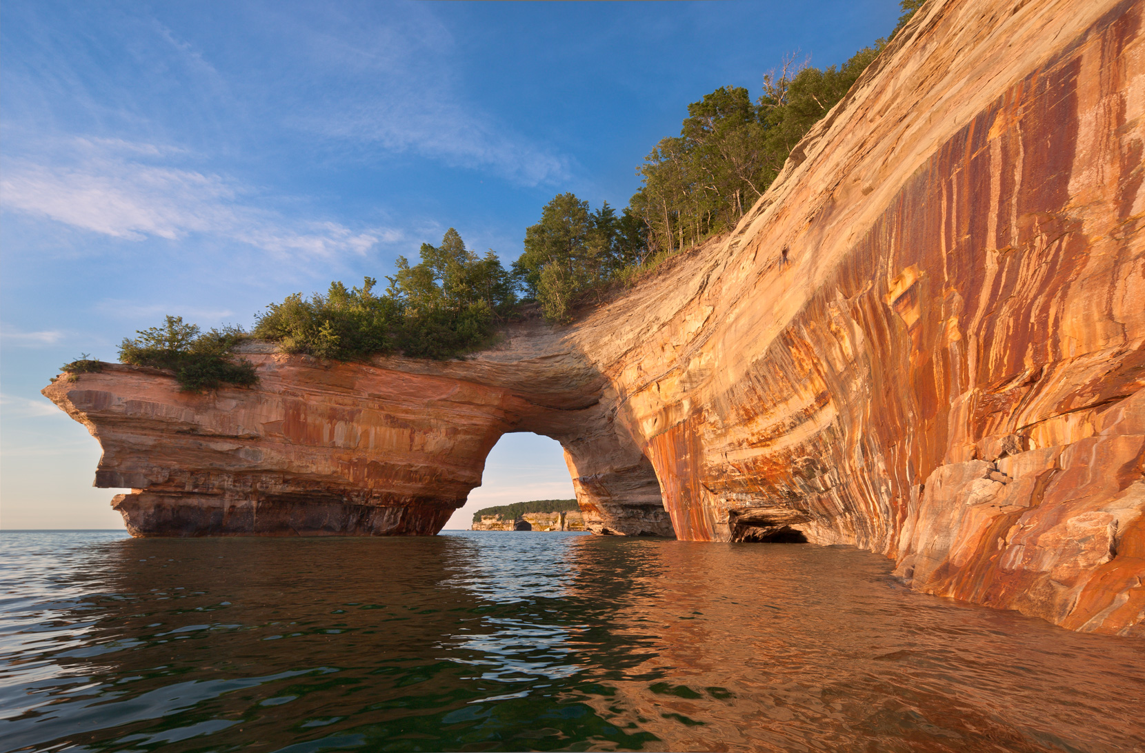 View of stone arch over water at Pictured Rocks.