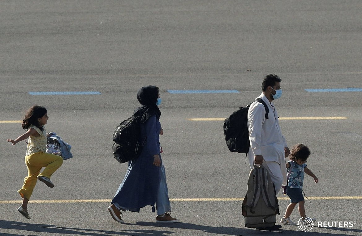 idreesali114's tweet photo. A girl skips across the tarmac as people evacuated from Kabul arrive at Melsbroek military airport in Belgium, August 25, 2021. REUTERS/Johanna Geron https://t.co/tZAbs9RpZg