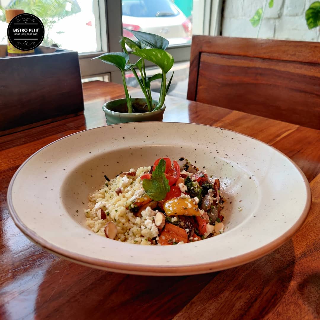 Dive into Moroccan Roast Vegetables (seasoned with ras al hanout) served on a bed of herbed couscous adorned with cranberries &amp; almonds and forget your stressful day. 

Visit us now to enjoy an endless combination of flavours.

 #bistropetit #Roasted #JustEat #