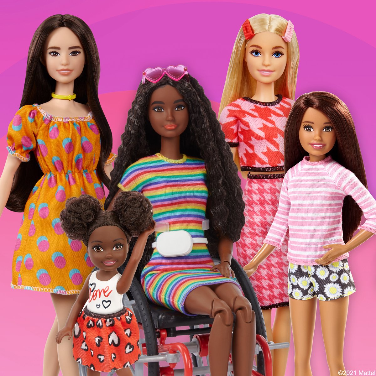 A diverse group of female dolls stand together.